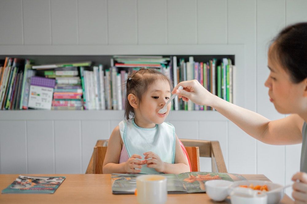 Mother feeding her child homemade food